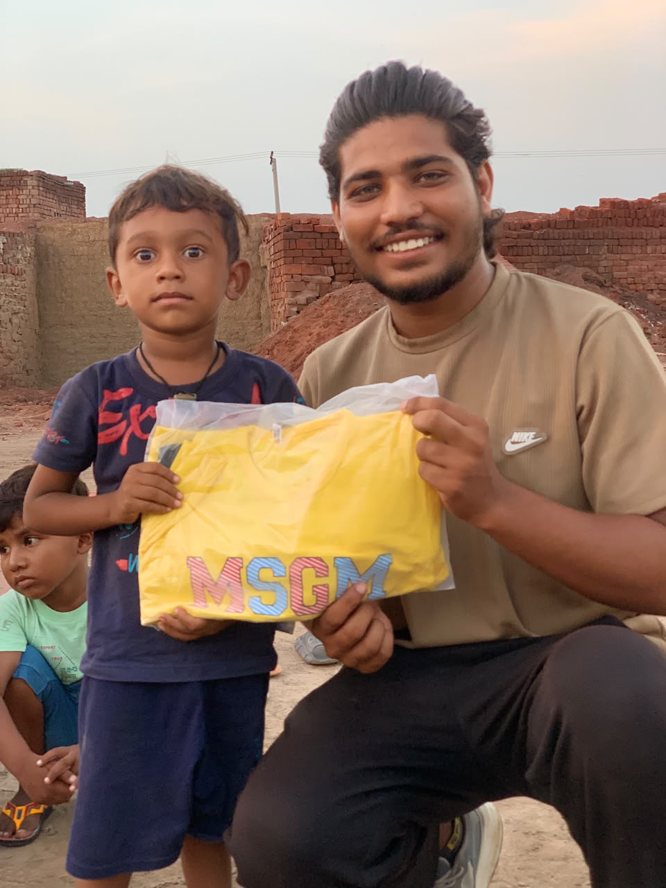A boy receiving a new shirt
