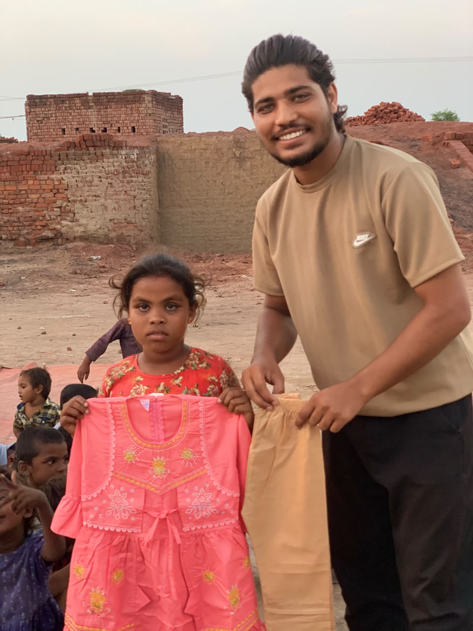 A girl holding a pink outfit